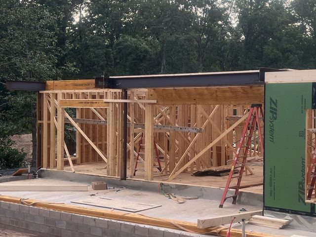 A house under construction with the framing exposed